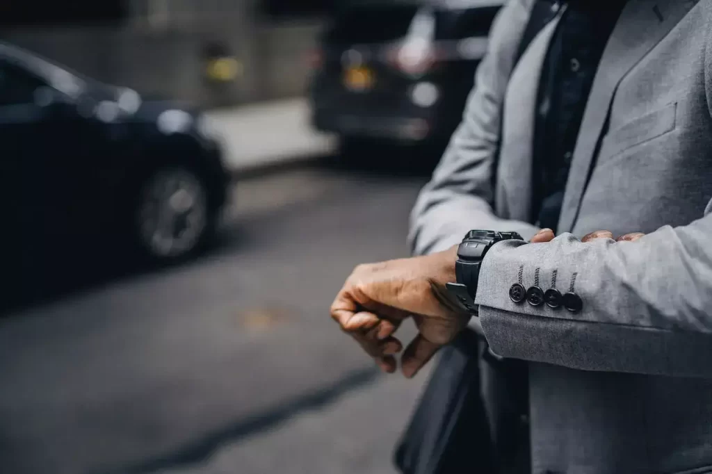 A guy in suit looking at the time