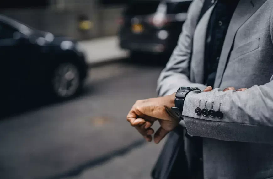 A guy in suit looking at the time