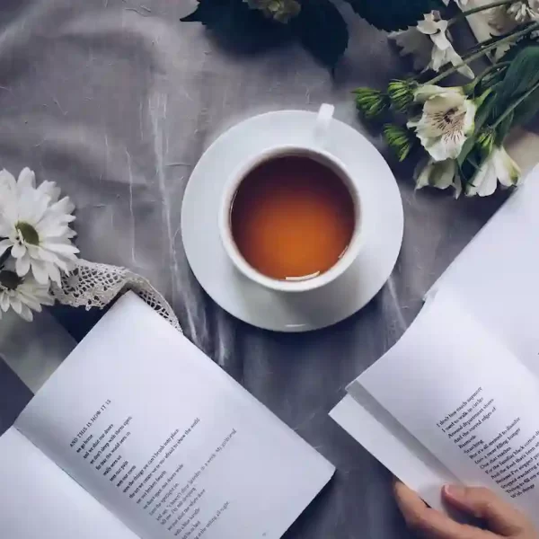 2 books on a table with a cup of tea