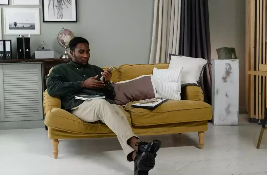 A business man sitting on the couch counting money