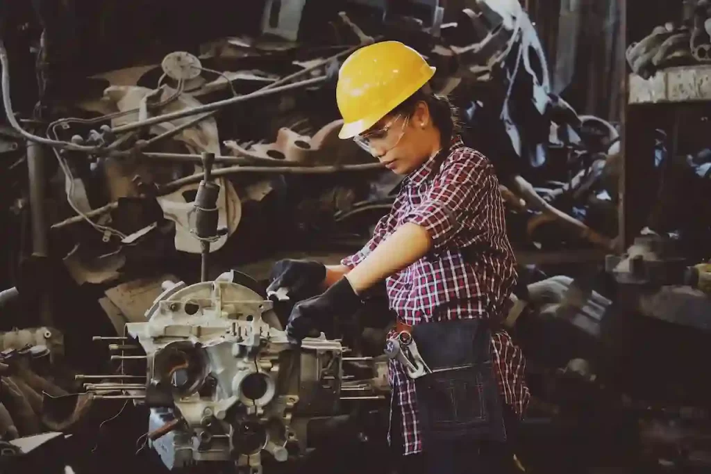 A woman working on an engine