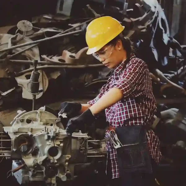 A woman working on an engine