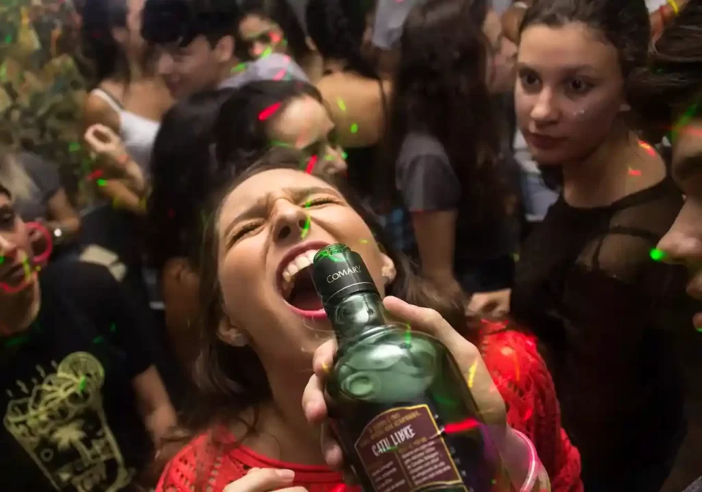 A girl drink alcohol in a party