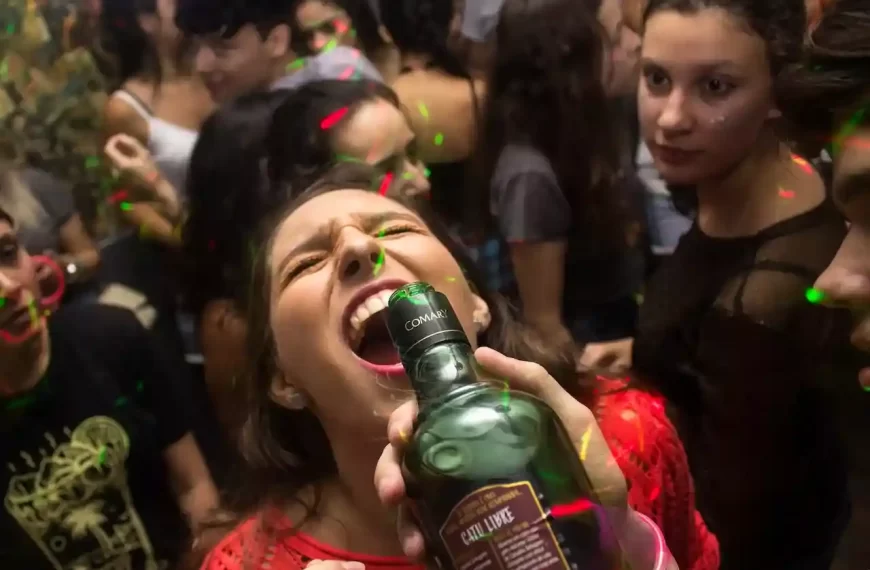 A girl drink alcohol in a party