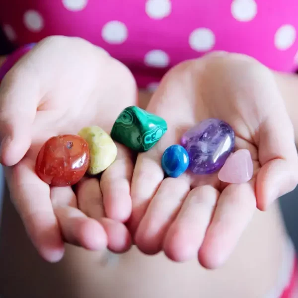 A girl with different colored polished stones