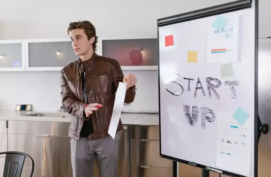 A guy presenting some papers in a meeting