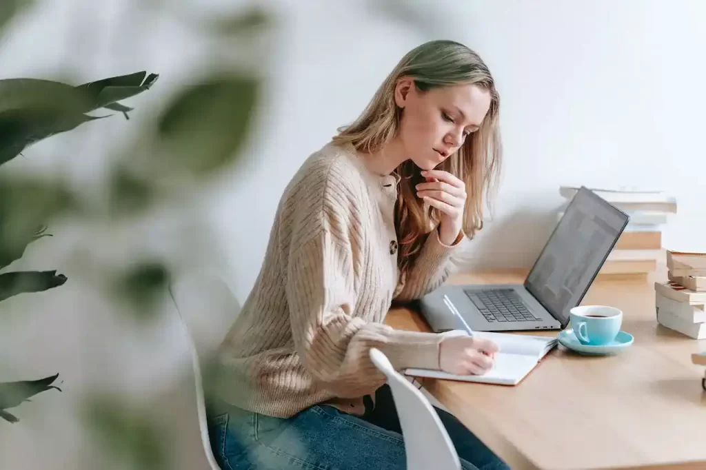 A woman sitting and writing notes