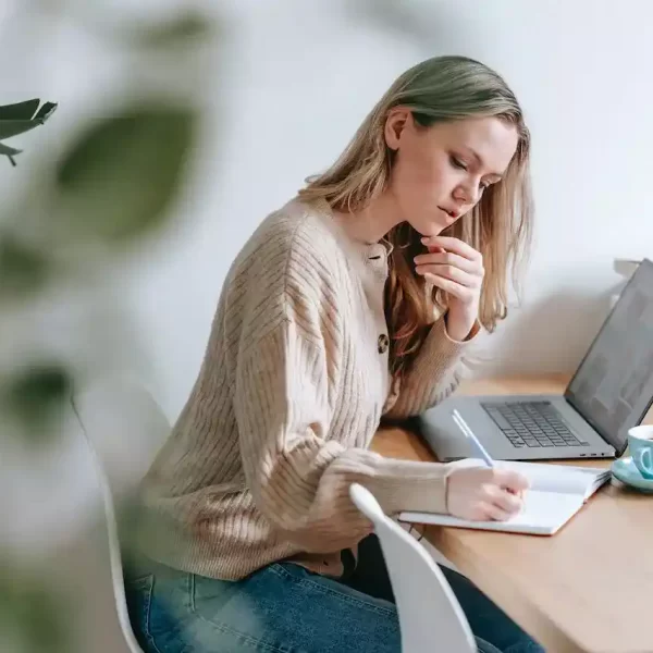 A woman sitting and writing notes