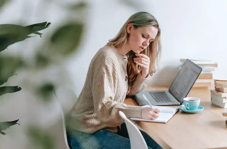 A woman sitting and writing notes