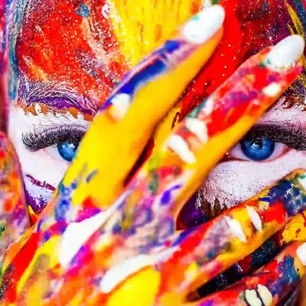 A close up of a girl with paint on her face and hand