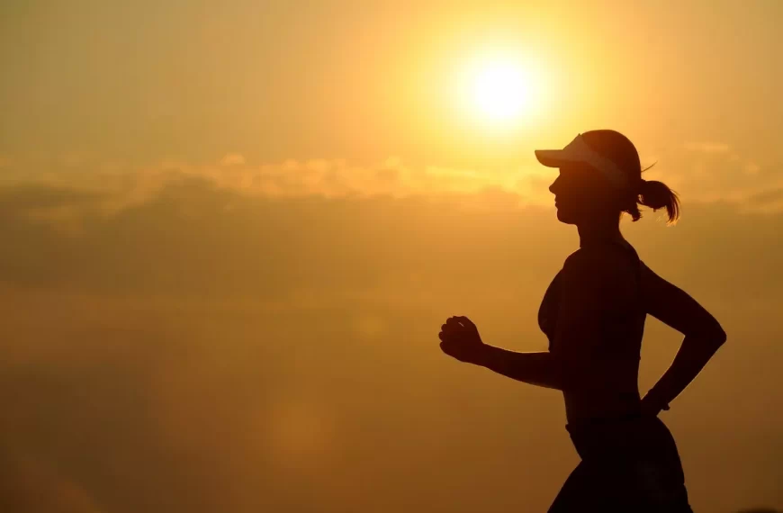 A girl running with run in the background