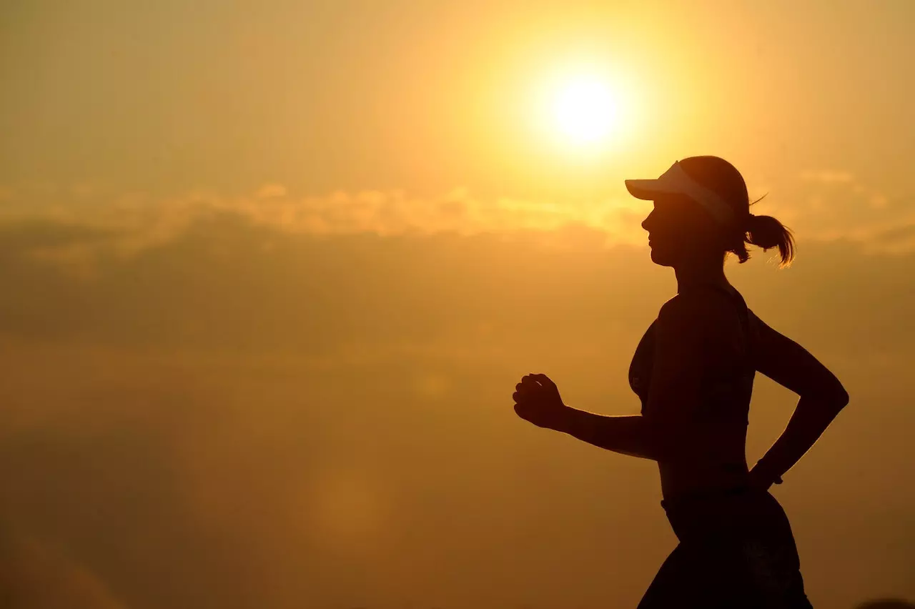 A girl running with run in the background