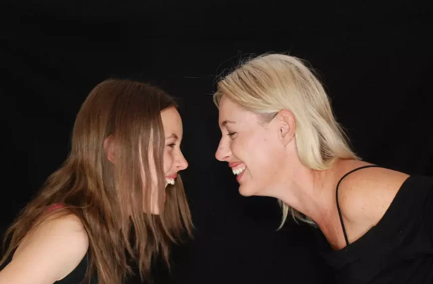 two women lookng at each other and laughing