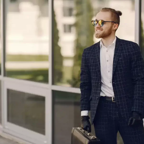 A cool guy in a black suit with sunglasses and a briefcase