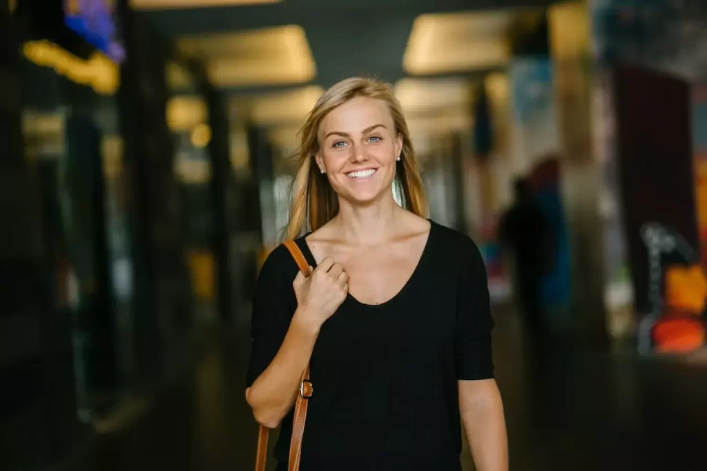 A woman walking and smiling confidently