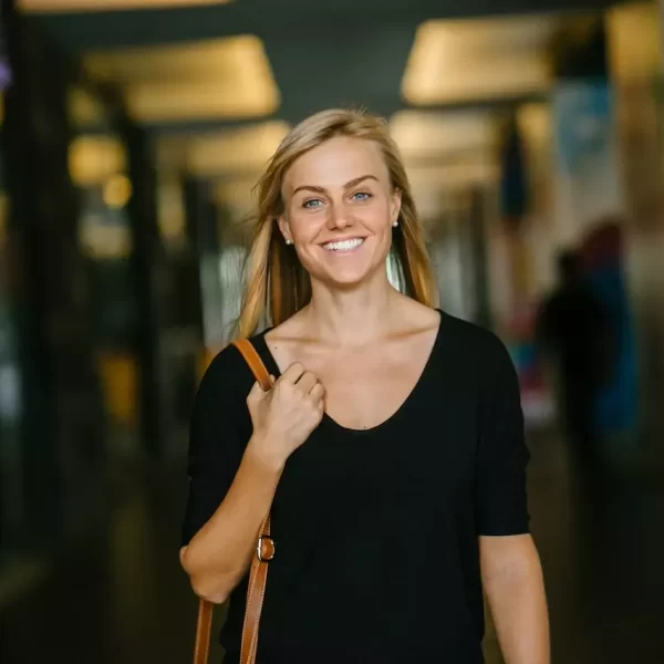 A woman walking and smiling confidently