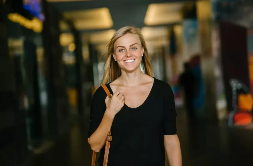 A woman walking and smiling confidently