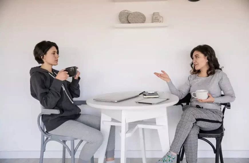 2 women having converstation with coffee in their hands