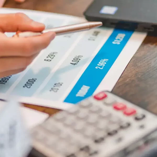 A close up shot of an agent pointing rates with a ballpen