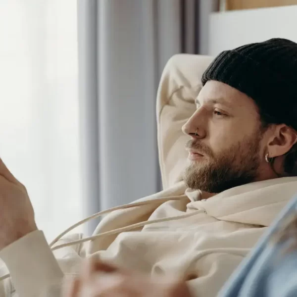 A man in bed looking at his cellphone