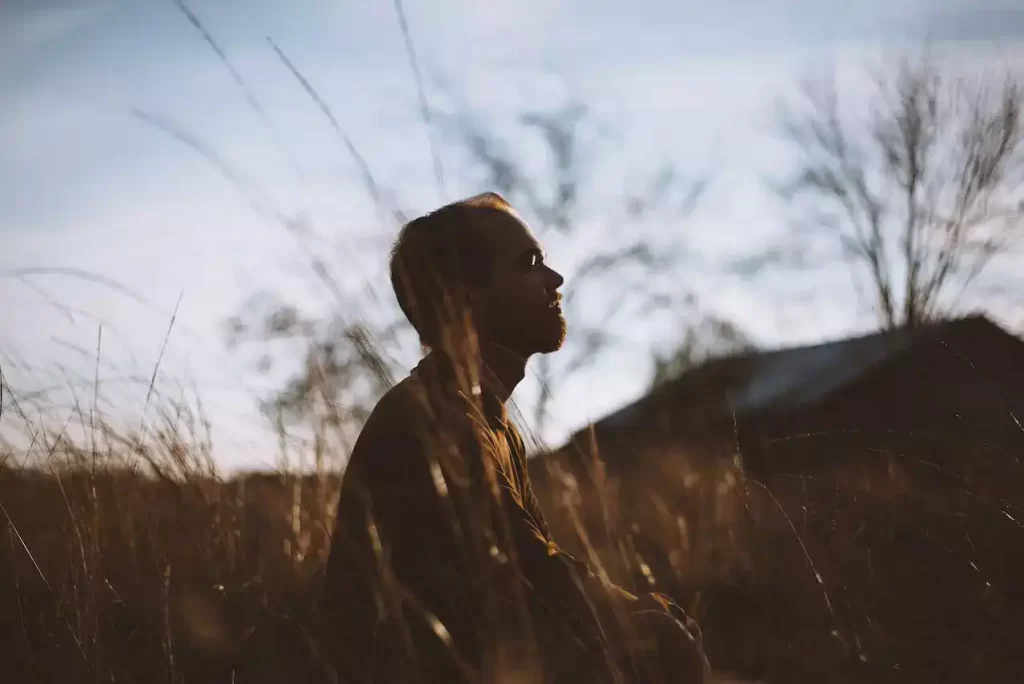 A silhouette of man meditating in the mountains