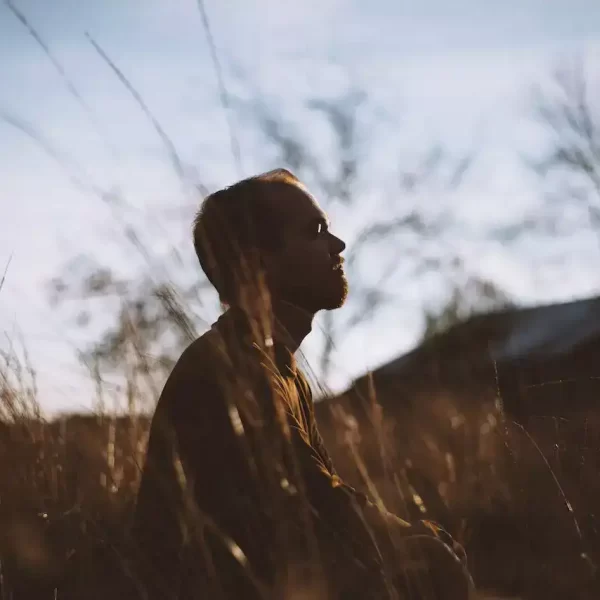 A silhouette of man meditating in the mountains