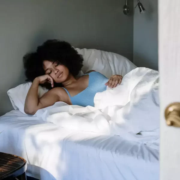 a woman calmly sleeping in her bed