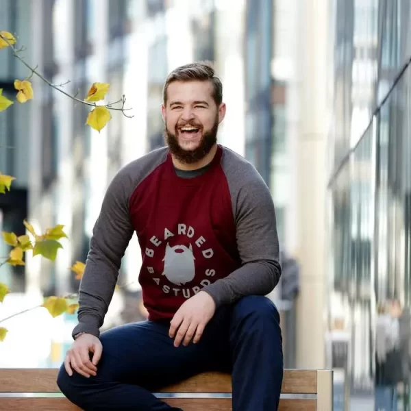 A guy sitting on a bench and laughing