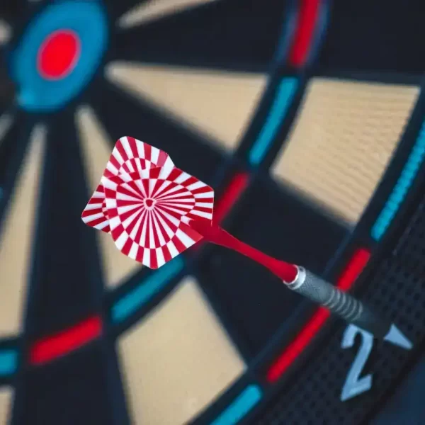 Red and white dart on a darts board