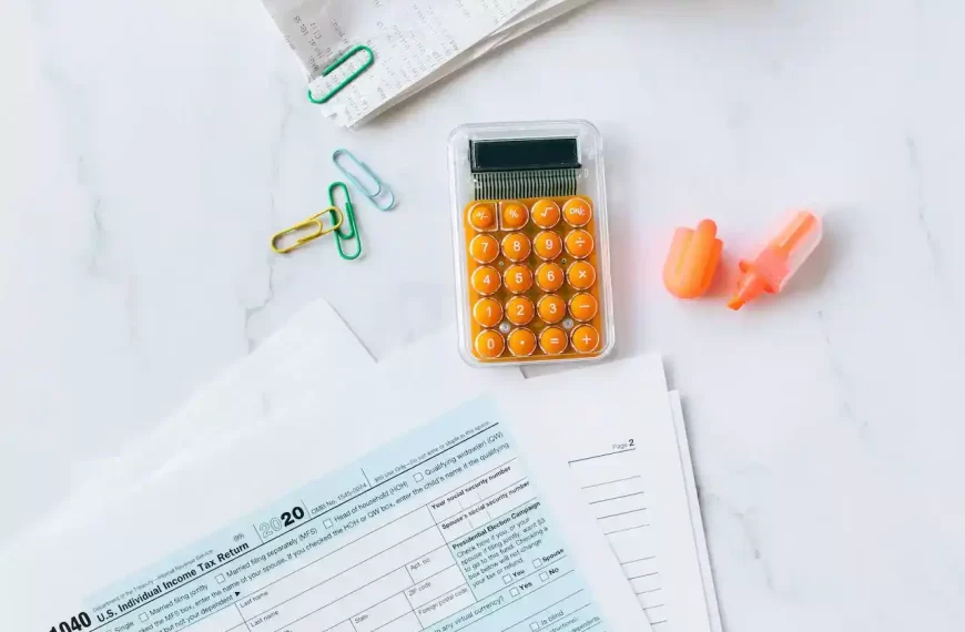 a calculator, highlighter, and bills on a table