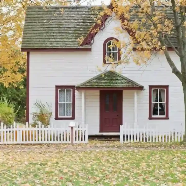 White and red wooden house with fence