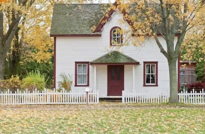 White and red wooden house with fence