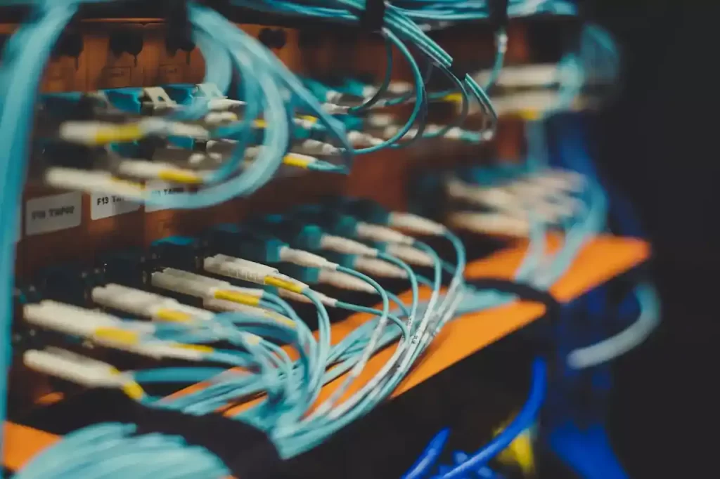 A bunch of wires connecting to a maching that looks like a server