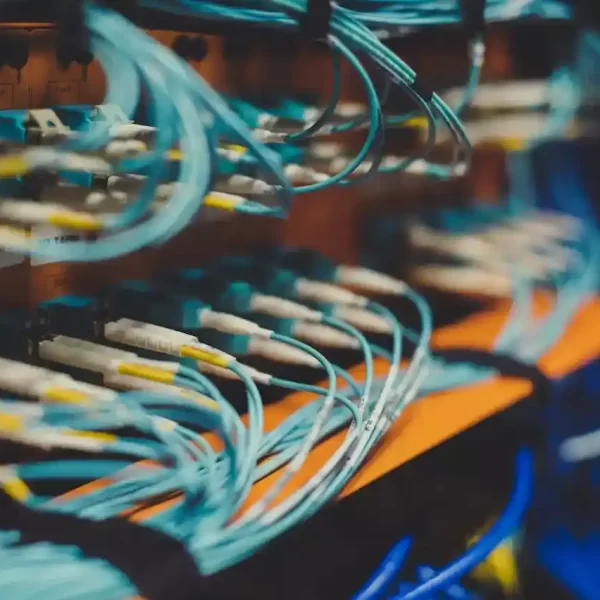 A bunch of wires connecting to a maching that looks like a server