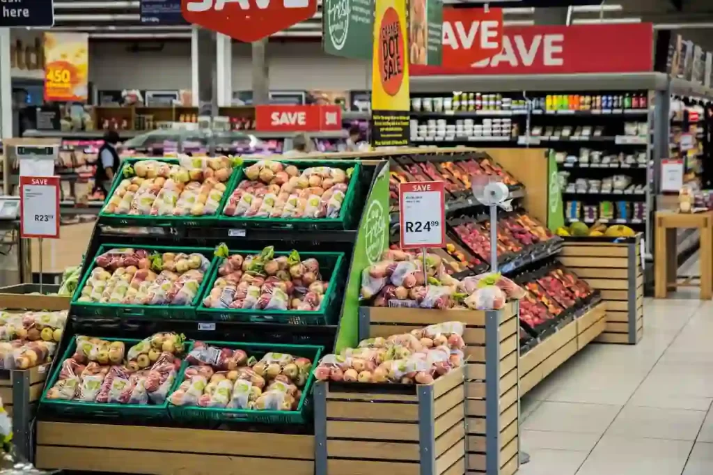 a section of different vegetables and fruits in a supermarket