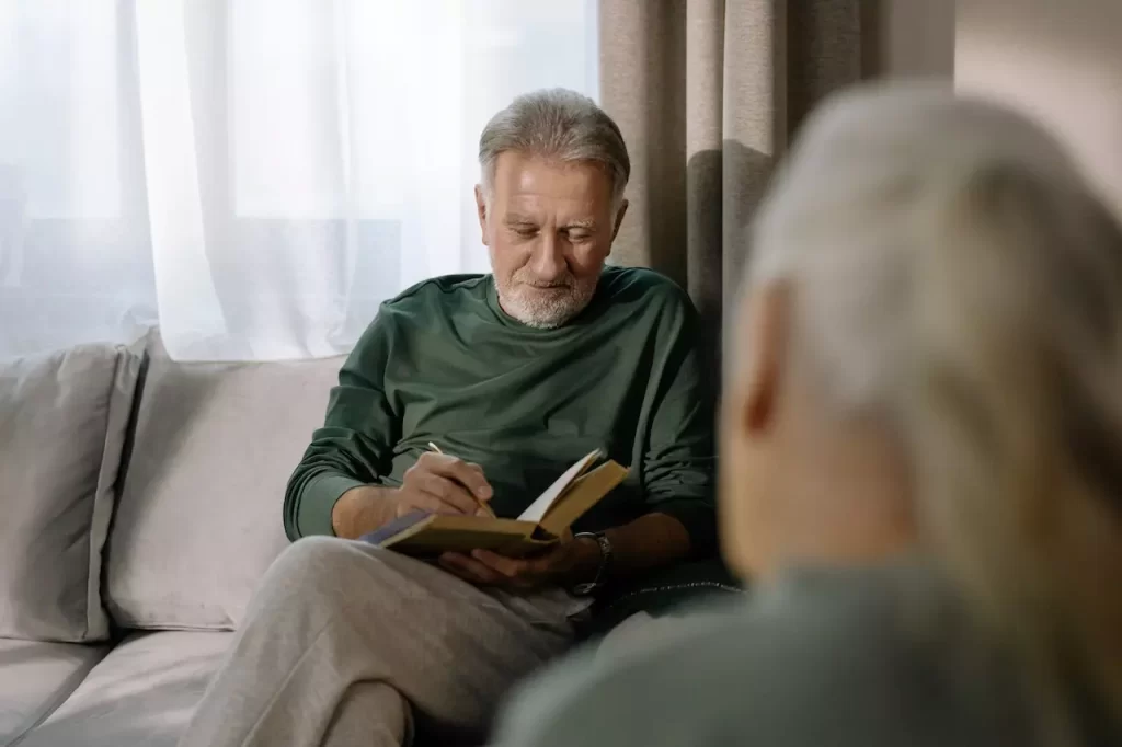 An elderly man reading a book