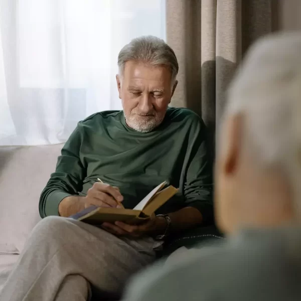 An elderly man reading a book