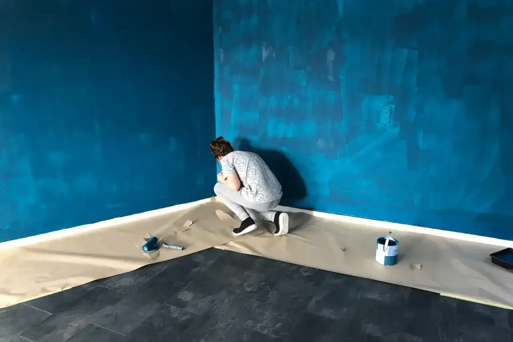 A woman painting the walls