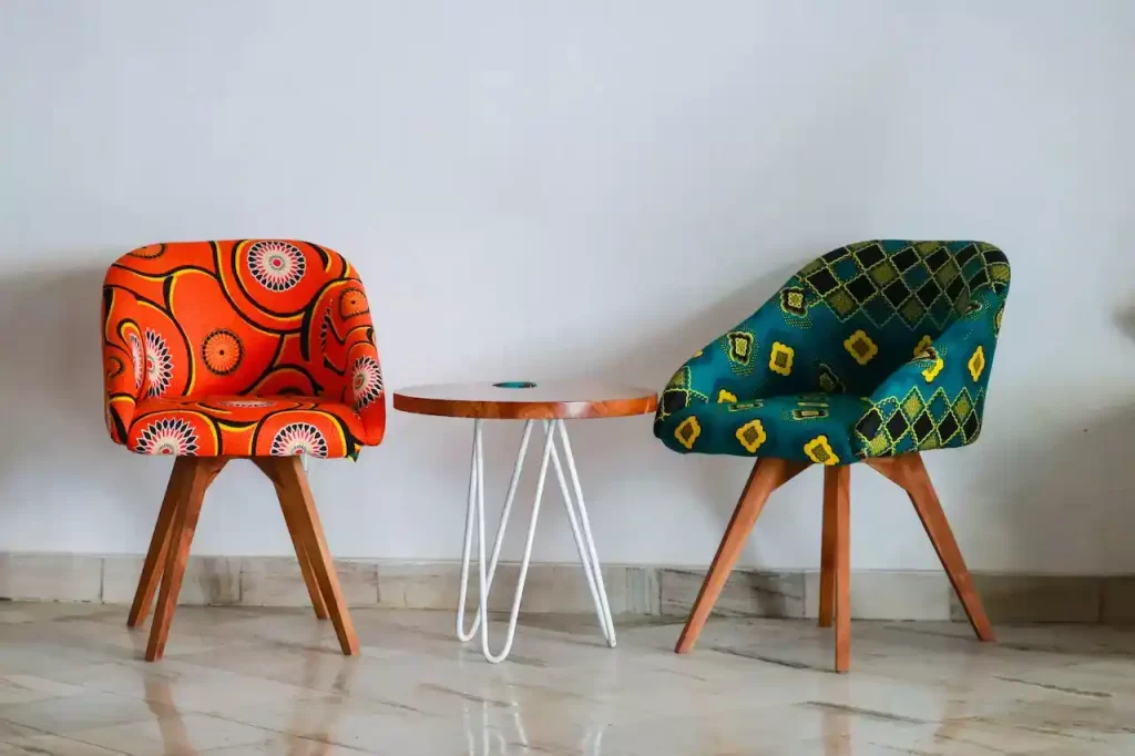 Two assorted color padded chairs near a side table