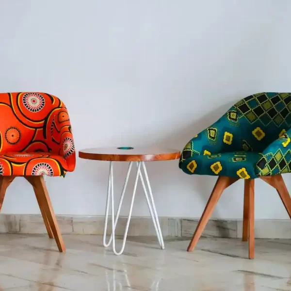 Two assorted color padded chairs near a side table