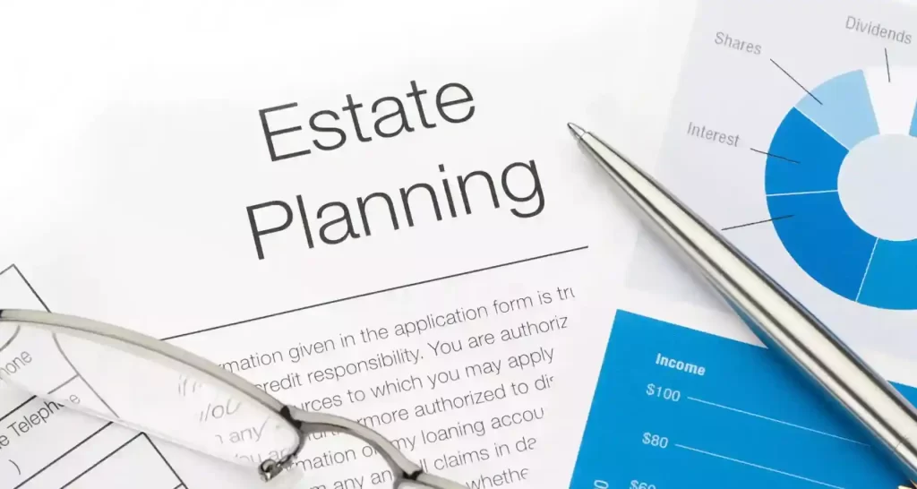 A paper with "estate planning" written on it with glasses and a pen besides it