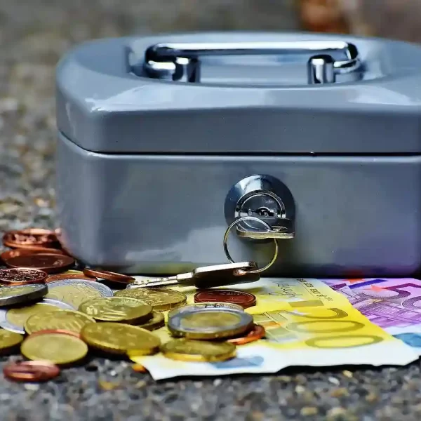 Cash box with coins and cash laying around it