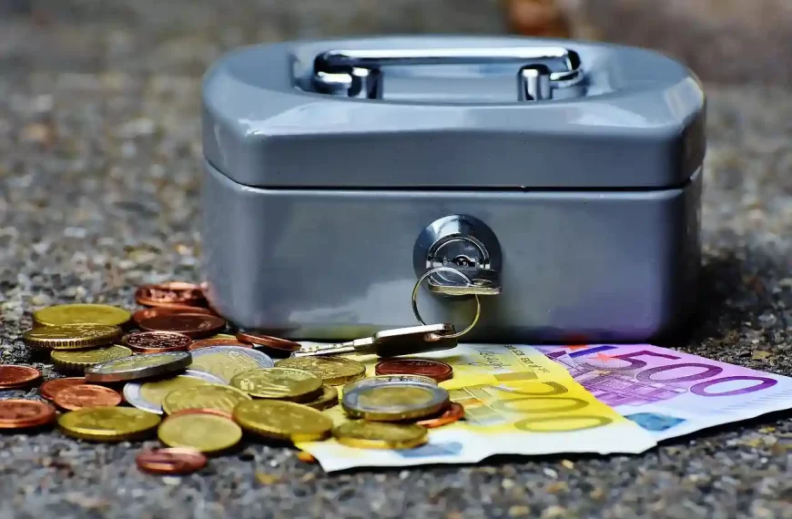 Cash box with coins and cash laying around it