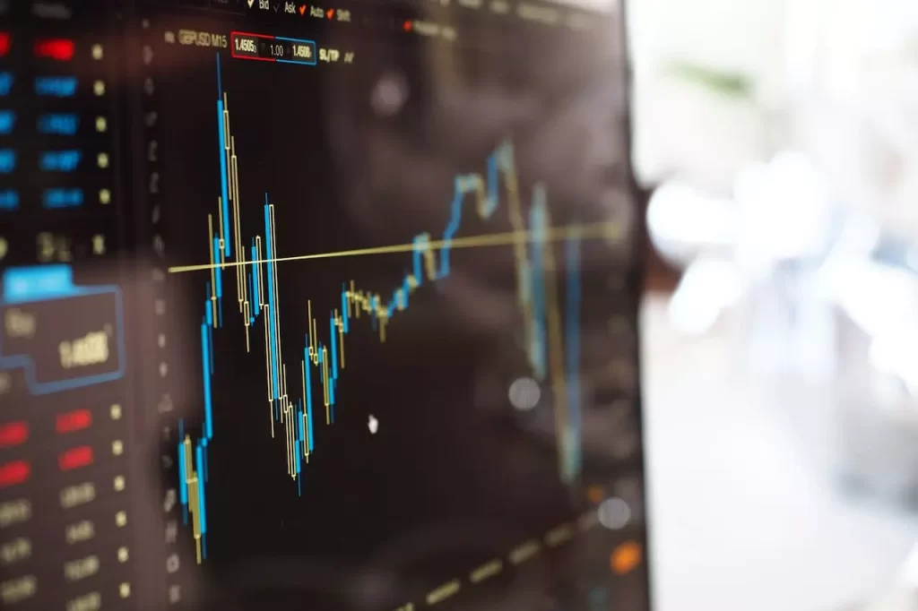 Close photo of a monitor showing candle chart of some stock