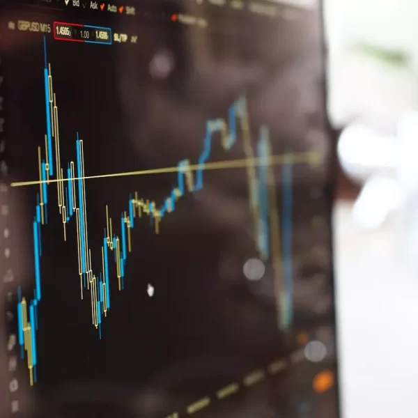 Close photo of a monitor showing candle chart of some stock