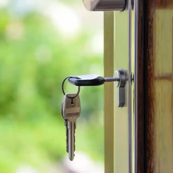 A key on a keyhole of a house door