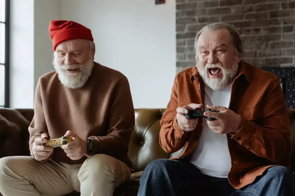 Two older gentlemen playing video games together