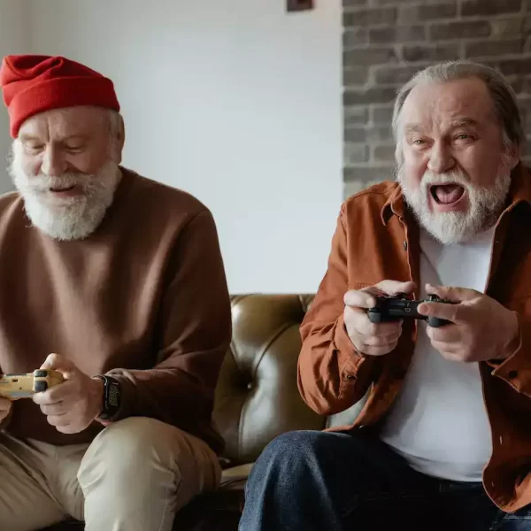 Two older gentlemen playing video games together