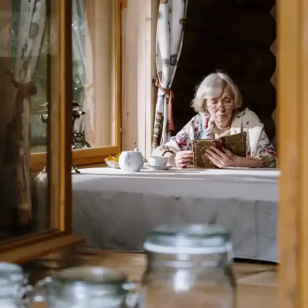 Elderly woman reading on a table