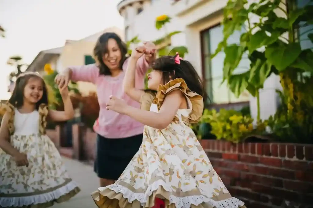 Mom dancing with her daughters on the street